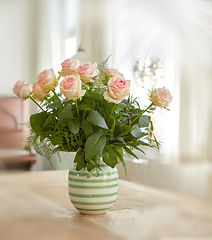 Image showing Closeup of bouquet of pink roses in a vase, nature and flowers on living room table, gift for romance or friendship. Plant, botanical and symbol of love, natural and floral arrangement at home