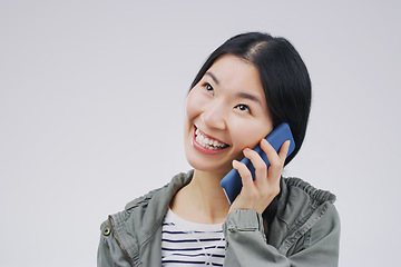 Image showing Phone call, happy and Asian woman in studio smile for conversation, talking and chatting. Communication mockup, white background and female person on smartphone for network, contact and connection