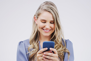 Image showing Smartphone, typing and woman in studio with smile for social media, internet and online chat. Communication, white background and happy female person on cellphone for website, mobile app and texting