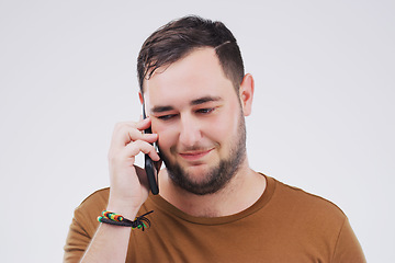 Image showing Chat, phone call and man listening in studio isolated on a white background. Calling, cellphone and male person talking, discussion or speaking, conversation and networking with contact on mobile.