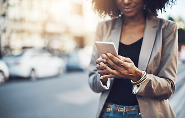 Image showing Woman, hands and phone in city for social media, communication or texting outdoors. Hand of business female chatting, online browsing or networking on mobile smartphone in street of an urban town