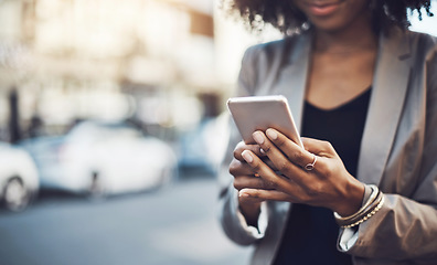 Image showing Woman, hands and phone in city for communication, social media or chatting and texting outdoors. Hand of business female on mobile smartphone for online browsing, travel or networking in a urban town