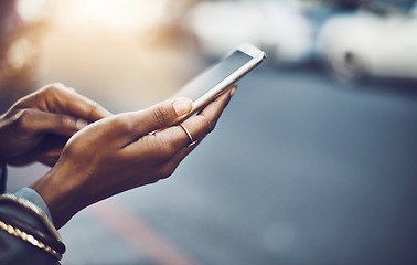 Image showing Woman, hands and phone in city for social media, communication or texting on street sidewalk outdoors. Hand of female chatting on mobile smartphone for networking, online browsing or travel in town