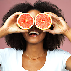 Image showing Grapefruit, happy and black woman covering her eyes in studio isolated on a pink background. Funny, fruit and African female model with vegan nutrition, vitamin c or healthy diet, food and wellness.