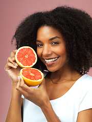 Image showing Grapefruit, happy and portrait of woman in studio isolated on a pink background, citrus detox or natural wellness. Face, fruits and african female model with vegan beauty, vitamin c and healthy diet