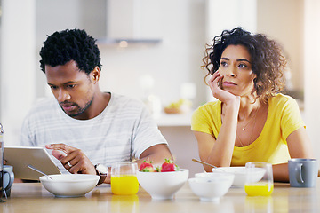 Image showing Technology, breakfast and man ignore woman for social media, reading news and digital app in morning. Marriage, couple and sad female and male on tablet with relationship problem, ignoring and issues