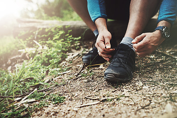 Image showing Tying laces, fitness and hands in nature to start walking, adventure or trekking for exercise. Shoes, sports and feet of a man getting ready for cardio, training or a walk for a workout in a park