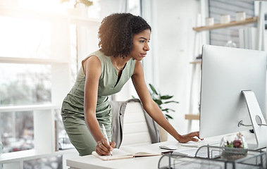 Image showing Computer, planner and business woman writing in a notebook or working by her desk or table in startup. Internet, online and professional female employee or worker planning company schedule