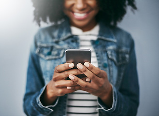 Image showing Hands, phone and woman with typing by wall background with excited smile, notification and meme on web chat. Closeup gen z girl, smartphone and texting for blog, post and video on social network app