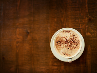 Image showing Top view wooden table, coffee cup or mock up restaurant, cafe or retail diner for beverage service, wellness drinks or espresso. Fresh caffeine aroma, warm latte and desk with morning hot chocolate