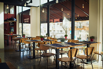 Image showing Empty restaurant cafe, deli or store for retail services, hospitality industry or sales service. Interior design decor, breakfast coffee shop and trendy small business with furniture, chair and table