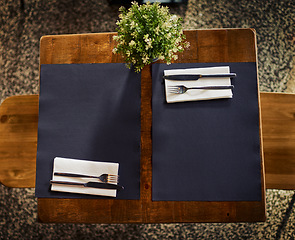 Image showing Wooden table, cutlery and restaurant knife, fork and napkin for cafe, coffee shop or modern retail store. Hospitality service, commerce and top view of empty desk, diner setting and eating utensils