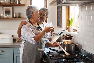 Image showing Cheers, wine and old couple at in kitchen cooking food together at stove with smile, love and romance. Toast, drinks and senior woman with man, glass and happiness to make dinner meal in retirement