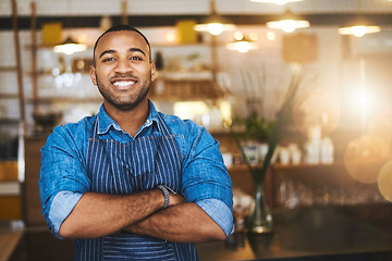 Image showing Coffee shop, barista and portrait of happy black man in restaurant for service, working and crossed arms. Small business owner, bistro and professional male waiter smile in cafeteria ready to serve