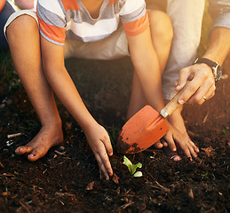 Image showing Hands of child, parent or plant in garden soil for sustainability, agriculture care or farming development. Natural, growth or closeup of farmers hand holding spade or planting for teaching a child