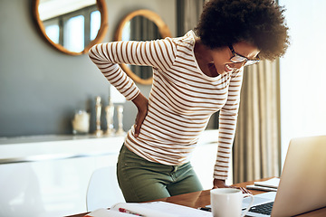 Image showing Black woman, laptop and back pain in remote work from bad posture, stress or overworked strain at home. African female person or freelancer holding painful area in discomfort, spine or ache by desk