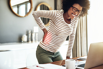 Image showing Black woman, laptop and back pain injury in remote work, stress or bad posture from overworked strain at home. African female person or freelancer with painful backache, spine or discomfort by desk