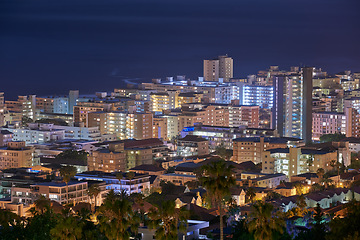 Image showing City, buildings and urban landscape at night, skyline and location with architecture, landmark and travel. Cityscape, skyscraper and Cape Town view for tourism, traveling and background destination