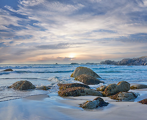 Image showing Rocks, beach and landscape with travel and ocean, environment and holiday destination in South Africa. Coastal location, nature and outdoor with seascape and tropical adventure with sea waves