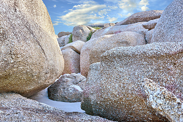 Image showing Rocks, beach sand and landscape with travel and environment, holiday destination in South Africa with nature outdoor. Coastal location, natural scenery and fresh air, seascape and tropical adventure