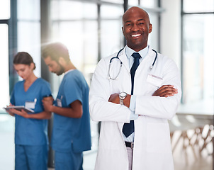 Image showing Leader, doctor and portrait of person in hospital, healthcare or clinic with medical expert nurses to trust in quality care. Black man, medicine and happy brain surgeon, arms crossed and confidence