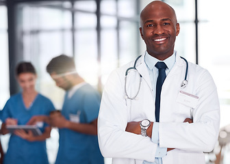 Image showing Doctor, leader and portrait of man in hospital, healthcare and clinic for medical experience, expert trust and quality care. Black person, medicine and happy surgeon with arms crossed for confidence