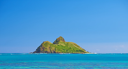 Image showing Blue water, tropical island and Hawaii with clear sky in summer in nature on holiday. Natural background, sunshine and sunrise at the ocean and beach of Oahu outdoor with calm sea and mockup space