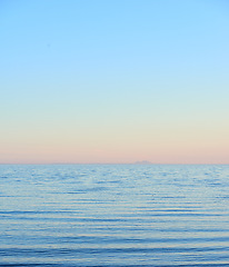 Image showing Blue water, tropical sea and Hawaii with clear sky in summer in nature on holiday. Natural background, sunshine and sunrise at the ocean and beach of Oahu outdoor with calm waves and mockup space