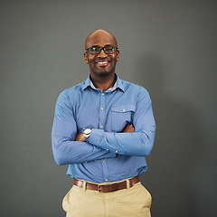 Image showing Business ceo, black man and portrait with arms crossed in a studio feeling proud from auditor work. Gray background, smile and African employee with success and leadership vision with glasses