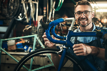 Image showing Portrait, smile and repair man working in bicycle shop, store and cycling workshop from Canada with glasses. Face, bike mechanic and confident male person, professional and happy mature technician