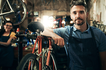 Image showing Serious, portrait and technician man in bicycle shop working in store or cycling workshop for repair. Face, bike mechanic and confident male person, business owner or mature professional with pride