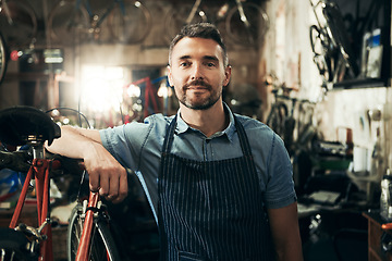 Image showing Portrait, serious and repair man in bicycle shop working in store or cycling workshop. Face, bike mechanic and confident male person, business owner or mature professional technician from Australia.