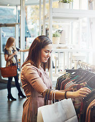 Image showing Retail, customer and woman with fashion, luxury and shopping with boutique items, selection and happiness. Female shopper, client and lady with clothes, sales discount and outfit choice in a store