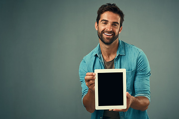 Image showing Happy man, tablet and advertising screen on mockup for marketing or branding against a grey studio background. Male person with smile showing technology display or mock up space for advertisement