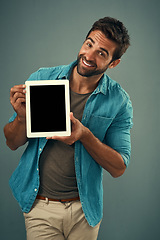 Image showing Happy man, tablet and mockup screen for advertising, marketing or branding against a grey studio background. Portrait of male person showing technology display or mock up space for advertisement