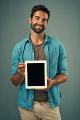 Image showing Happy man, tablet and portrait with mockup screen for advertising or marketing against grey studio background. Male person with smile showing technology display or mock up space for advertisement