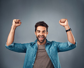 Image showing Happy man, fist and celebration for winning, achievement or success against a grey studio background. Excited portrait of male person or winner in victory, win or accomplishment on mockup space