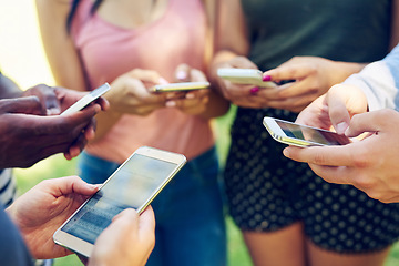 Image showing Hands, phone and circle for texting, friends and contact on social media app, web or internet in park. Men, women and smartphone in group for connectivity, online gaming or outdoor in summer together