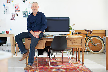 Image showing Portrait, office and creative business man for graphic design career, workspace confidence and startup mindset. Professional manager, boss or designer person relax on desk with computer in creativity