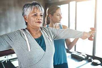 Image showing Dumbbell, physiotherapy and old woman with personal trainer for fitness, wellness or rehabilitation. Health, workout or retirement with senior patient and physiotherapist in gym for support training