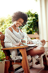 Image showing Black woman, reading and backyard patio with book and coffee feeling relax and happy. Happiness, African female person and smile in a home garden in the morning with tea outdoor in the sun with story