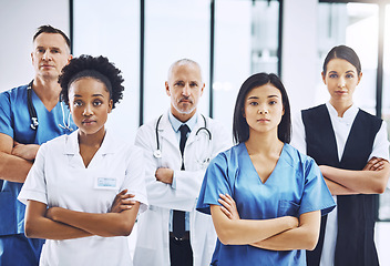 Image showing Medical, crossed arms and portrait of group of doctors standing in the hallway with confidence. Serious, diversity and team of professional healthcare workers in a medicare clinic or hospital.