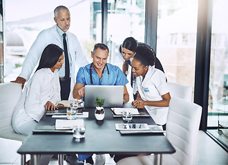 Image showing Doctor, diversity and laptop in team meeting for healthcare strategy, planning and collaboration in a hospital. Group of doctors, teamwork and discussion on computer technology with medical students