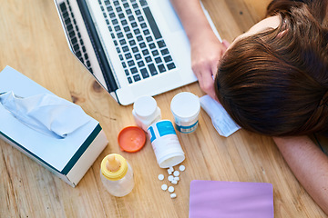 Image showing Top view, sick and woman with a laptop, sleeping and burnout with medicine, tired and career. Female person, professional or employee with medication, healthcare issue or problem with pills or tissue