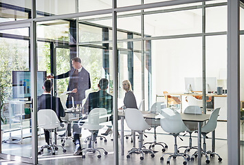 Image showing Presentation, colleagues planning and in a business meeting of their modern workplace office together. Teamwork or collaboration, brainstorming or ideas and coworkers in a workshop for data review