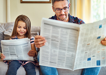 Image showing Happy father, daughter and reading newspaper on sofa for knowledge, literature or news in living room at home. Dad, child and smile for family bonding, learning or education on lounge couch together