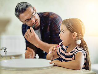 Image showing Child, father and brushing teeth in bathroom, bonding and cleaning together. Dad, girl and toothbrush for dental hygiene, oral wellness or healthy tooth for family care, teaching and learning in home