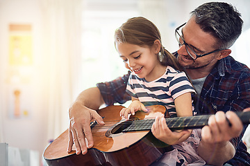 Image showing Learning, guitar and girl, man with smile for music or bonding or love or play at house. Happiness, teaching and kid, father with acoustic or musical instrument for fun or education at family home.