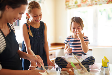 Image showing Mom laughing, happy family or kids baking in kitchen with siblings learning or mixing cookies recipe. Funny, home or mother helping or teaching playful children to bake together for cooking skills