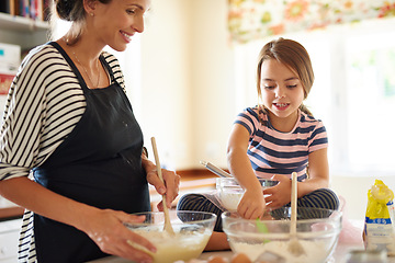 Image showing Mother, cooking or girl child baking in kitchen as a happy family with a young kid learning cookies recipe. Cake, baker or mom helping or teaching daughter to bake for skills development at home